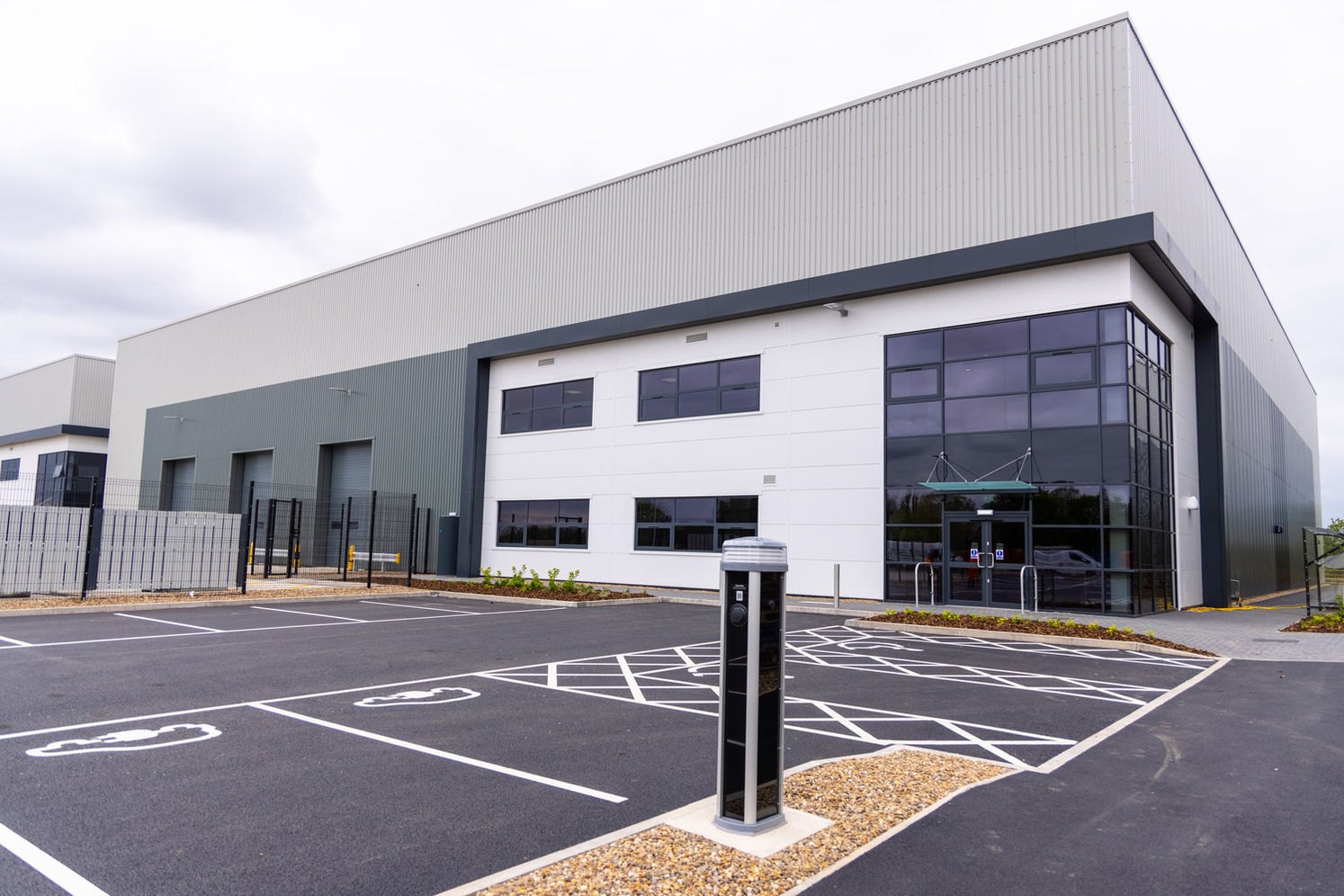An industrial unit with marked EV charging bays