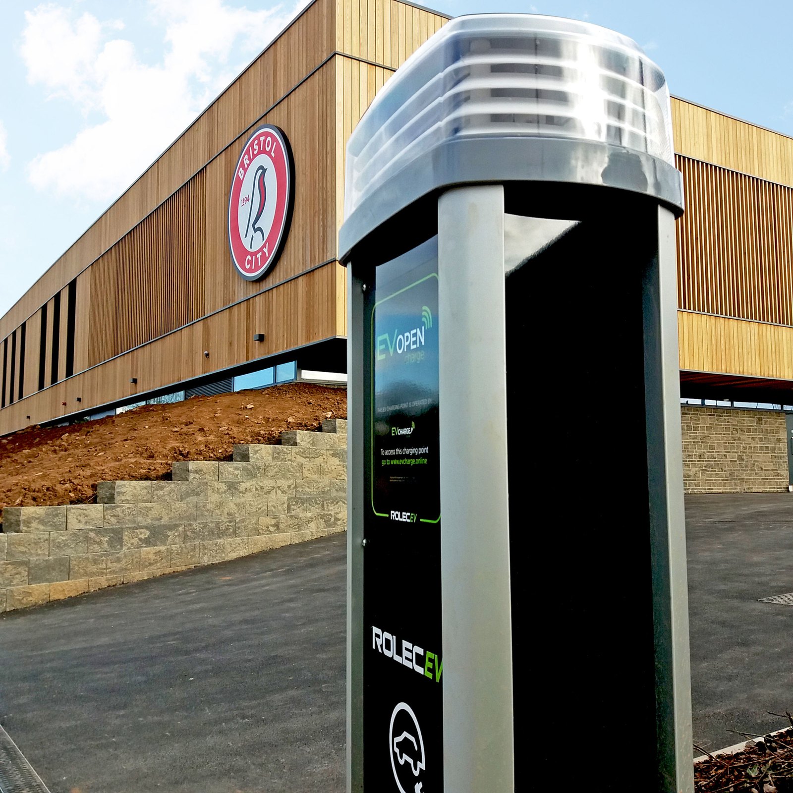 A commercial charging pedestal in a car park