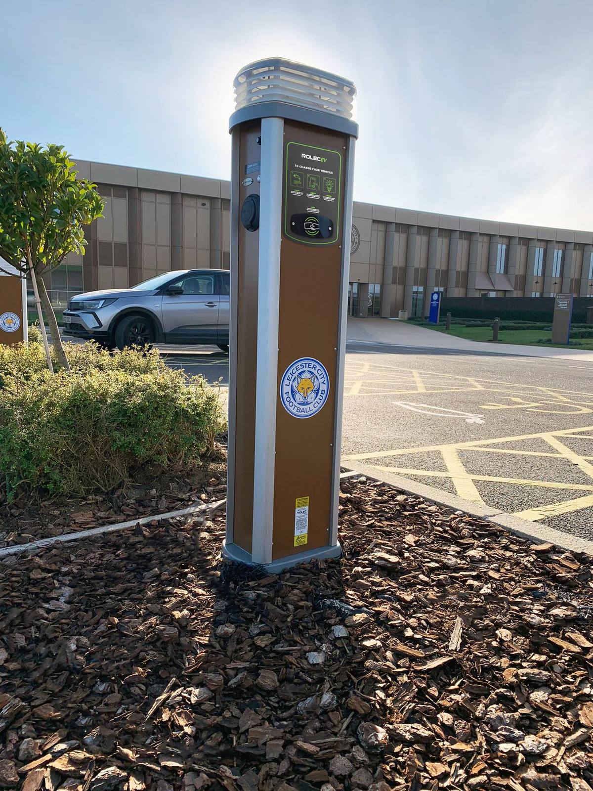 A free-standing charging pillar in a residential car park